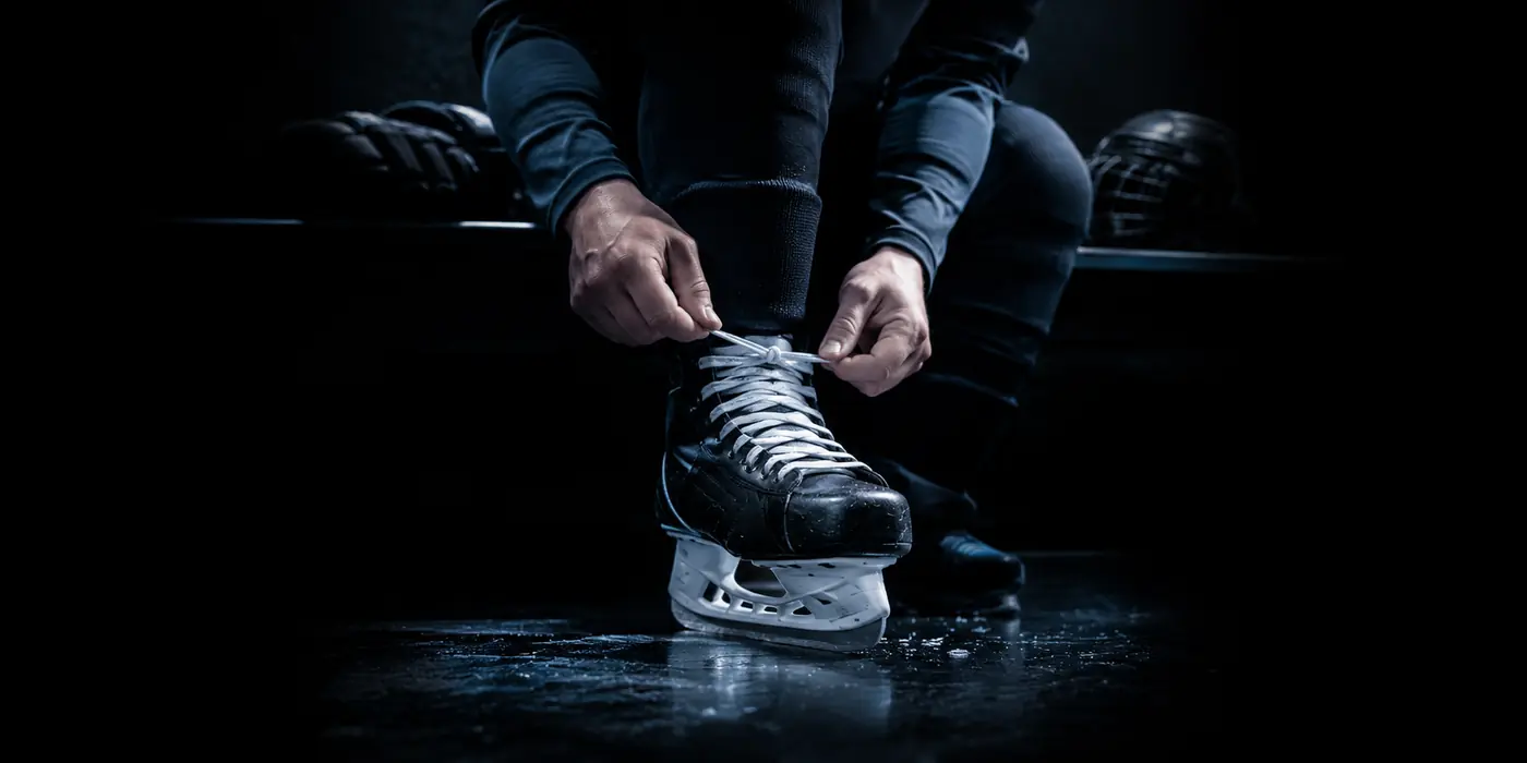 Hands lacing a hockey skate