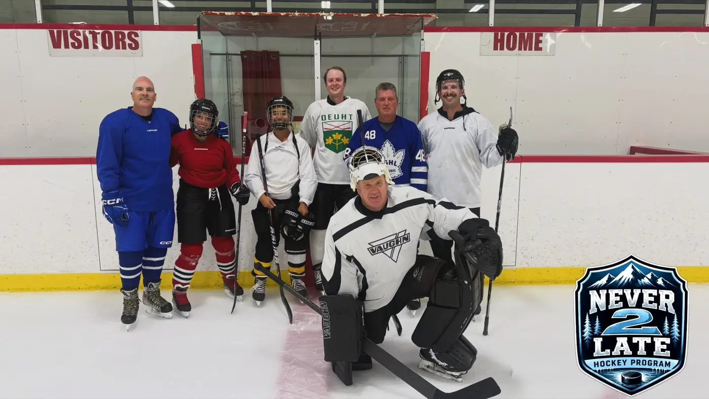 Hockey participants and a goalie together on the ice
