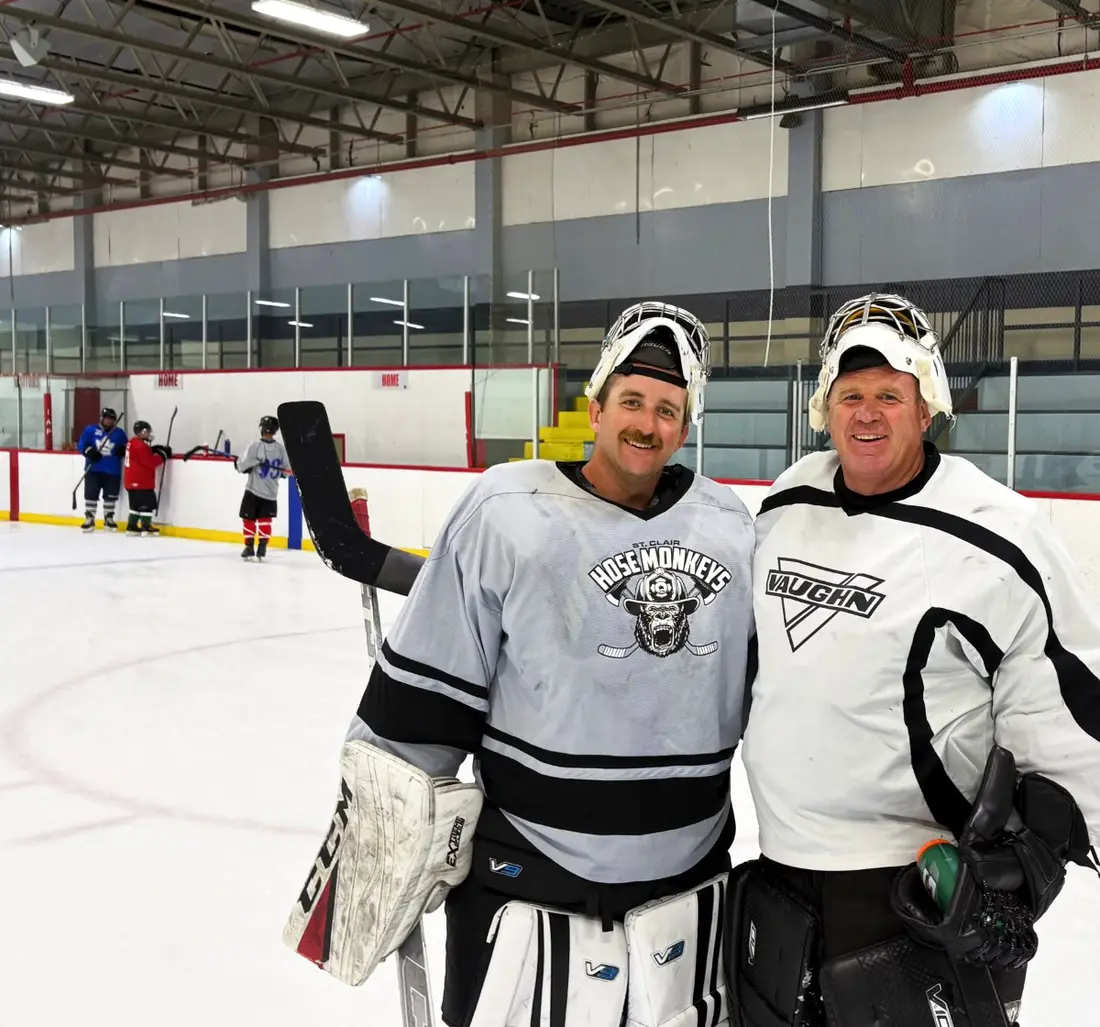 Two goalies smiling together