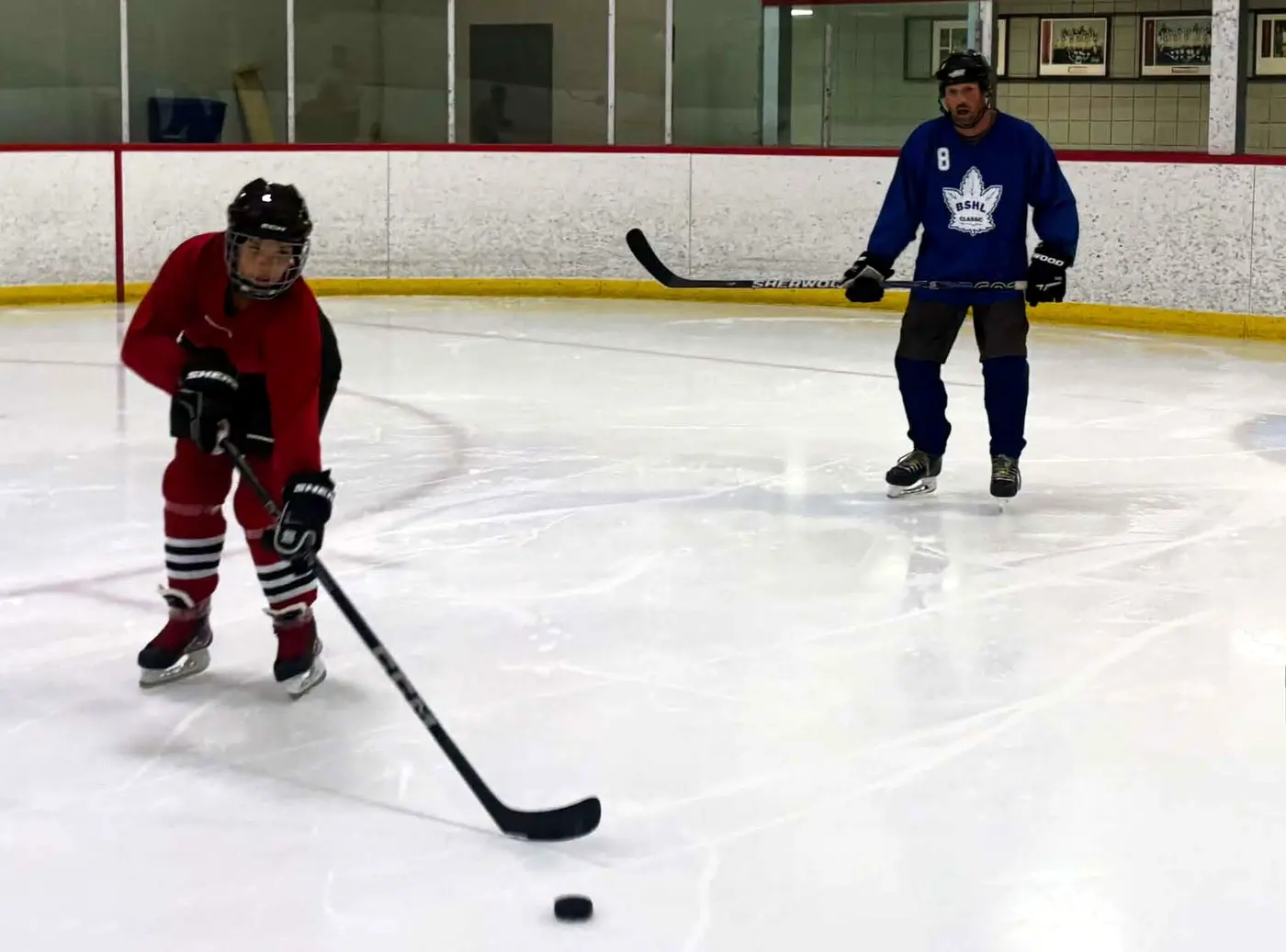 Two players completing a skating drill