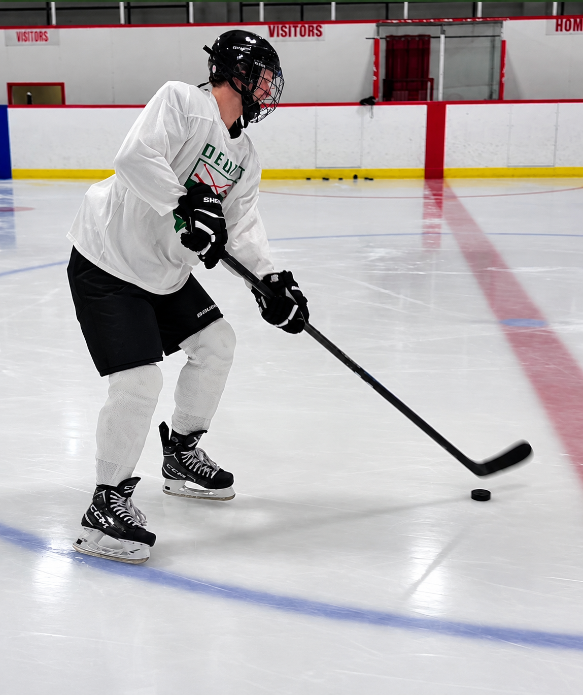 Hockey player practicing puck control on the ice